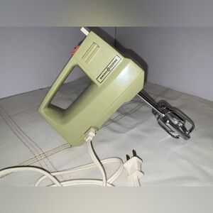 vintage General Electric hand mixer known as the "Avocado Green" model from1970s